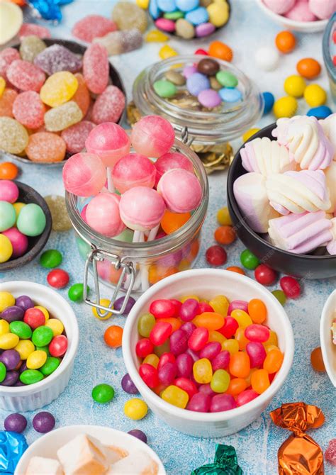 Premium Photo | Pink lollipop candies in jar with various milk ...