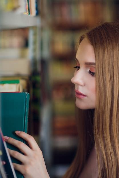 Beautiful female student in university library | Premium Photo