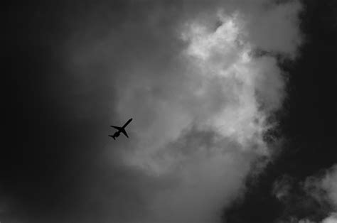 Low angle view of airplane flying against cloudy sky | Premium Photo