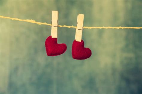 Two red hearts are hanging on the rope on the blue wooden background. # ...