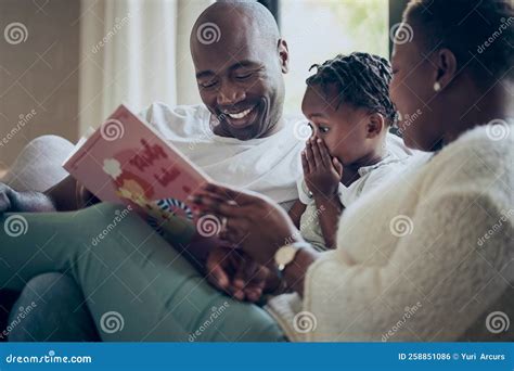 I Didnt See that Coming. a Young Family Reading a Book Together at Home. Stock Photo - Image of ...