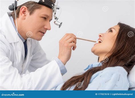 Otolaryngologist in Ent Headlight Examining Throat Stock Photo - Image of physician, medicine ...