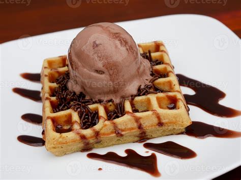 chocolate waffle with ice cream topping and chocolate sprinkles ...