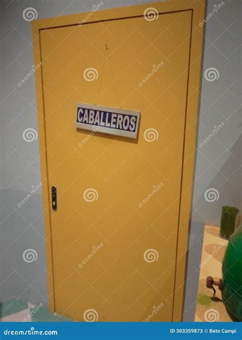 Gray Wall, Yellow Door with Sign Saying CABALLEROS in Spanish Which ...