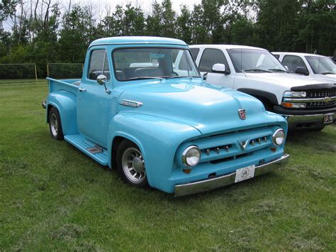 Classic Blue Pickup Truck in a Grassy Field
