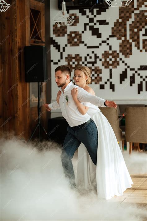 Premium Photo | The first dance of the bride and groom inside a restaurant