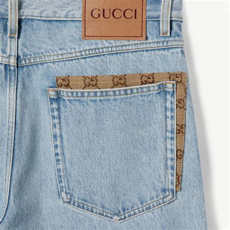 Pantalone in denim délavé con inserto GG in celeste | GUCCI® Italia