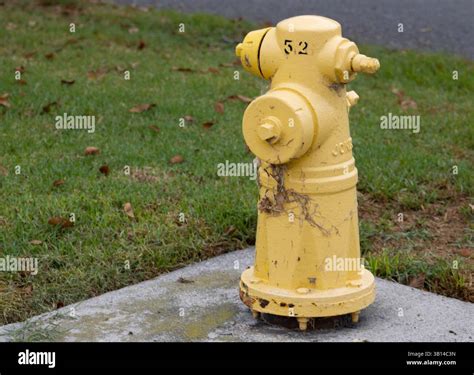 yellow fire hydrant on sidewalk Stock Photo - Alamy
