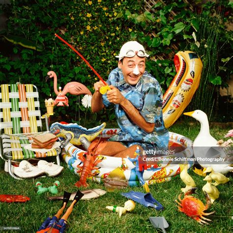 Pee-Wee Herman kneels in a kiddie pool, wears a swim cap with... News ...
