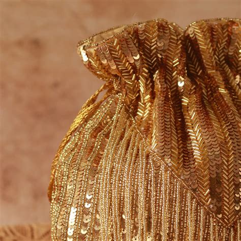 THE TAN CLAN Twinkle Heavy Tassles Potli with Handle - Gold