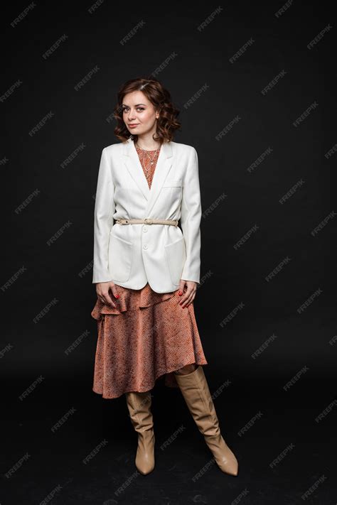 Premium Photo | Handsome woman in long dress and boots poses, picture ...