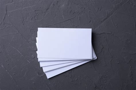 Stack of blank business cards on dark surface | Premium Photo