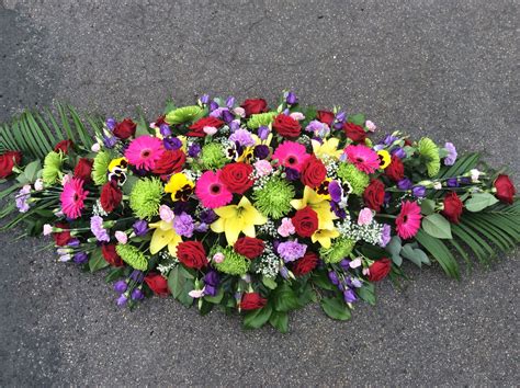 Gorgeous bright, mixed flower casket spray | Funeral flower ...