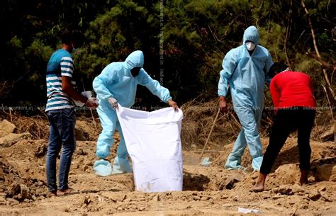 Buy Health workers and relatives during cremation of their relative in ...