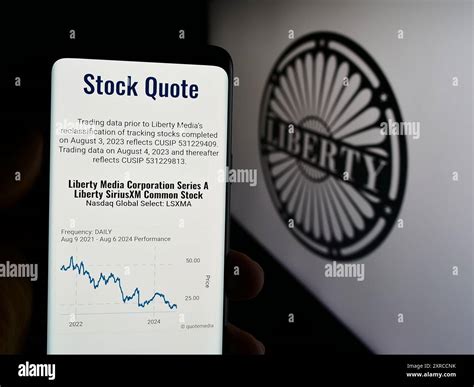 Person holding cellphone with webpage of US mass media company Liberty ...
