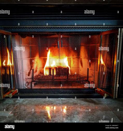 A fire burning in a living room fireplace Stock Photo - Alamy