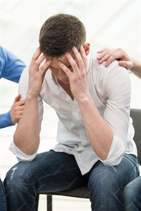 Depressed young man is sitting at the chair. | Premium Photo
