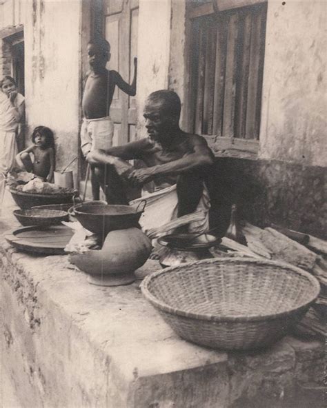 Man Sitting with Utensils and Baskets, Woman and Children looking ...
