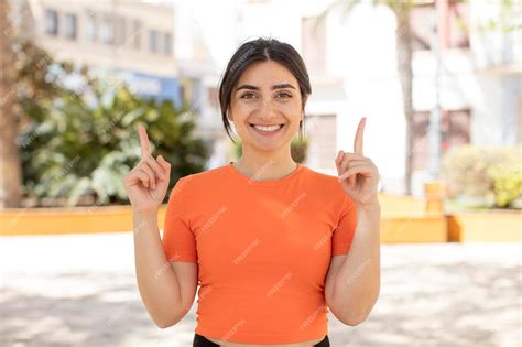 Premium Photo | Feeling awed and open mouthed pointing upwards with a ...