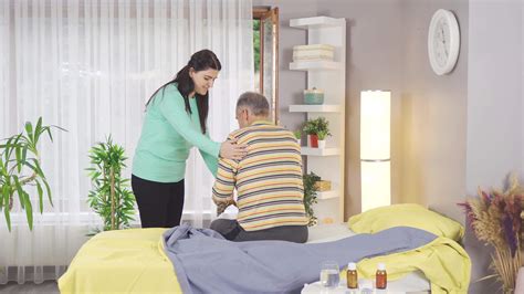 Nursing woman helping old sick man and showing love. Sick man alone ...