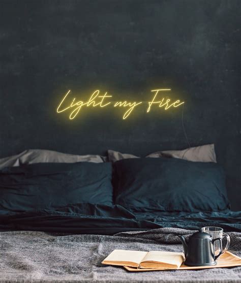 Neon Words Light My Fire in Red on a Wall Sign