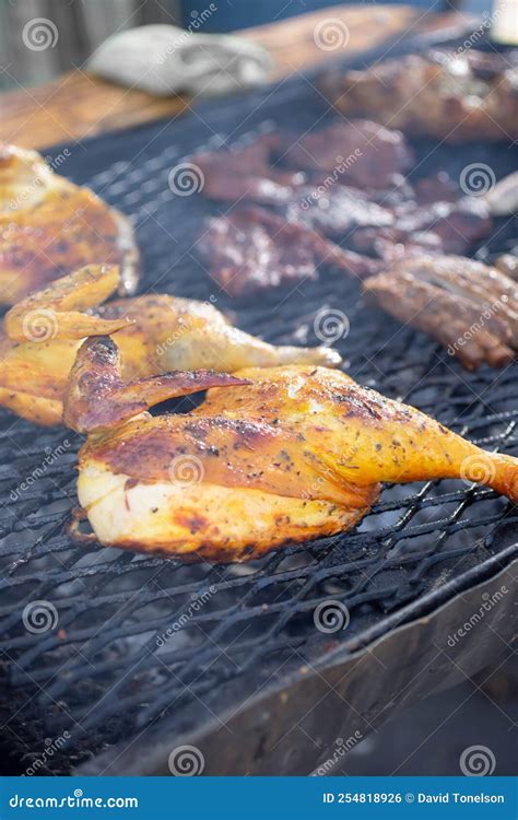 Pollo asado on the grill stock photo. Image of butcher - 254818926
