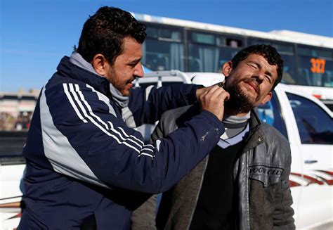 Shi'ite fighters fire a rocket during clashes with Islamic State ...