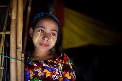A Rohingya refugee girl named Rufia Begum, aged 9, poses for a ...