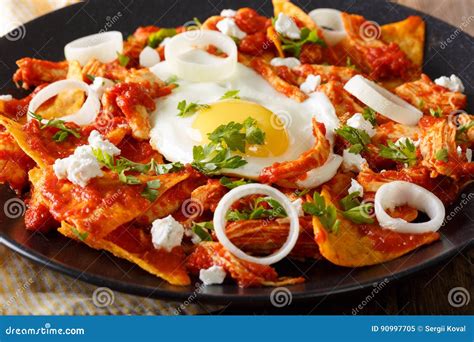 Mexican Breakfast: Chilaquiles with Egg and Chicken Close-up. Ho Stock ...
