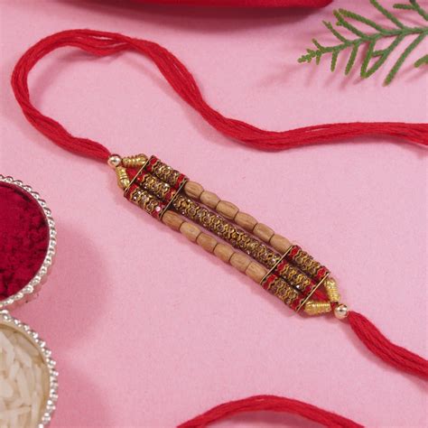 DELICATE PEARL BEADED MAROON RAKHI WITH ROLI CHAWAL & RAKSHABANDHAN CA