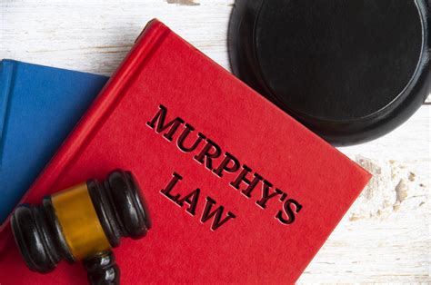 Top view of Murphy's Law book on wooden table with gavel background ...