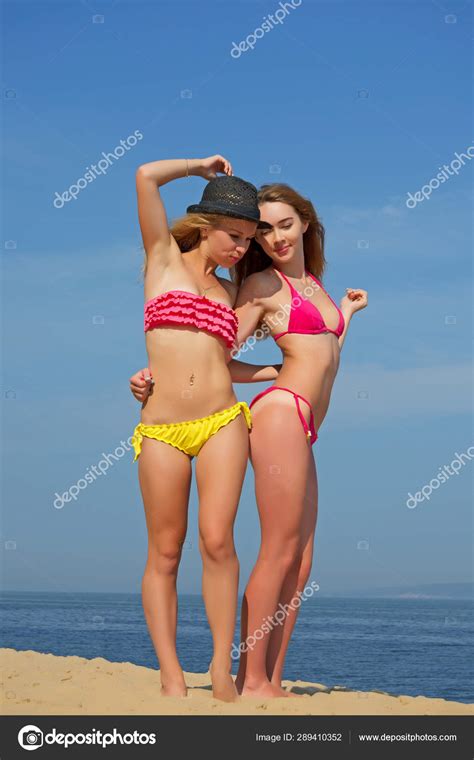 Girls in thongs on the beach. — Stock Photo © rrraum #289410352