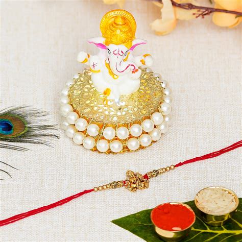 Designer Ganesha Rakhi with Lord Ganesha Idol on Decorative Handcrafted ...