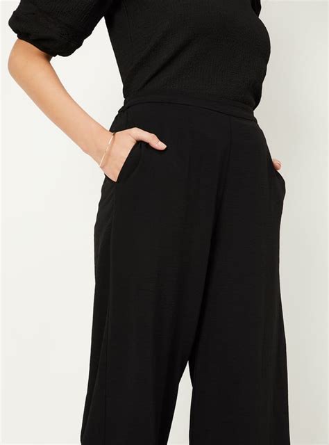 Buy Women Solid Wide Leg Trousers Online at just Rs. 899.0 ...