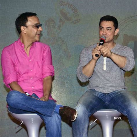 Aamir Khan speaks as Vidhu Vinod Chopra looks on during an event to ...