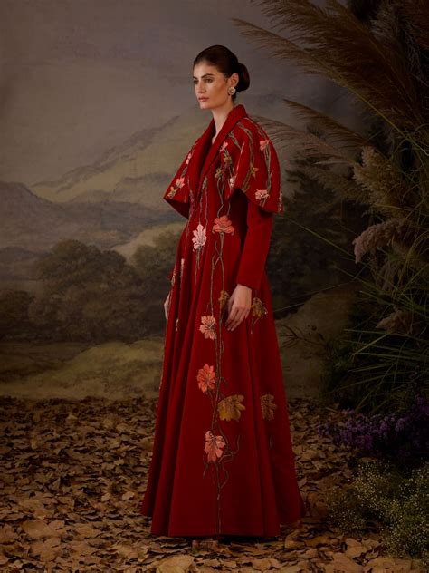 A red velvet fabric floor length gown with lapel neck line & extended ...