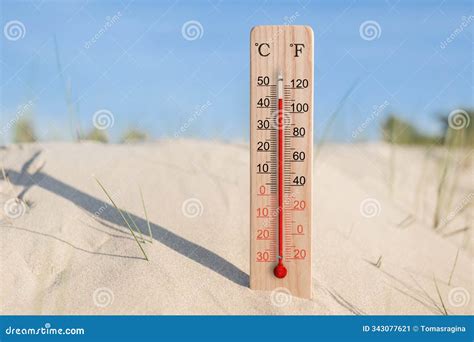 Wooden Celsius and Fahrenheit Scale Thermometer in the Sand. Ambient ...
