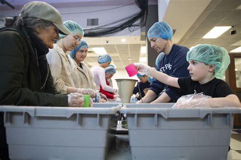 Hundreds Volunteer at Pioneer High School to Create 50K Meals - mlive.com