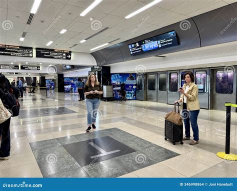 People Waiting for a Train Being Transported To an Airport Gate at the ...