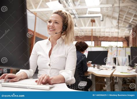 Female Customer Services Agent Working at Desk in Call Center Stock ...
