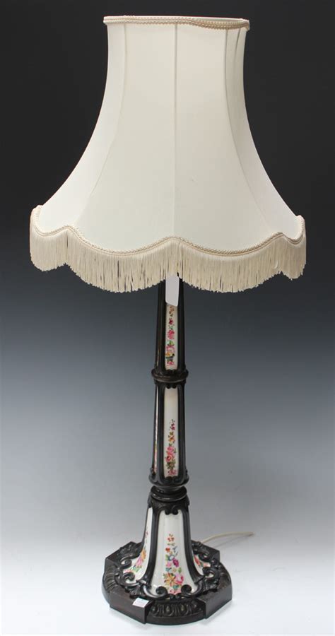 A late Victorian brown patinated cast bronze and porcelain table lamp ...