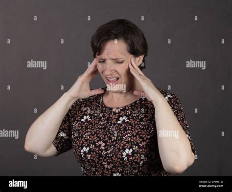 Overweight Fifty something woman having a headache Stock Photo - Alamy