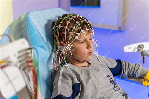 Premium Photo | EEG electrode placement to patient during EEG record ...