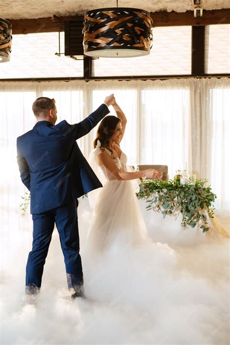 Premium Photo | The first dance of the bride and groom inside a restaurant