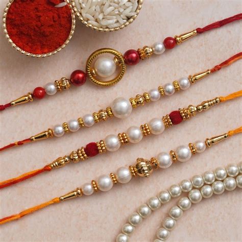 Buy eCraftIndia 4 Red, Golden White Pearls Rakhis with Roli Chawal Pack ...