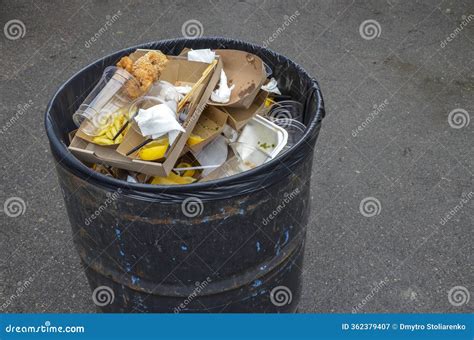 Overflowing Black Trash Bin Outdoors, Filled with Various Types of ...