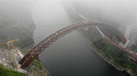World's longest-span asymmetric arch bridge closes in central China - CGTN