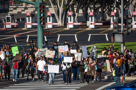 Protesters rally outside Angel Stadium against ICE sweeps in Anaheim ...