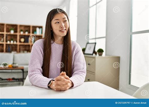 Young Chinese Girl Smiling Happy Sitting on the Table at Home Stock Image - Image of cool ...