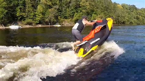 A woman performing a stunt on her Sea-Doo Spark with the words “Make Waves sales event”